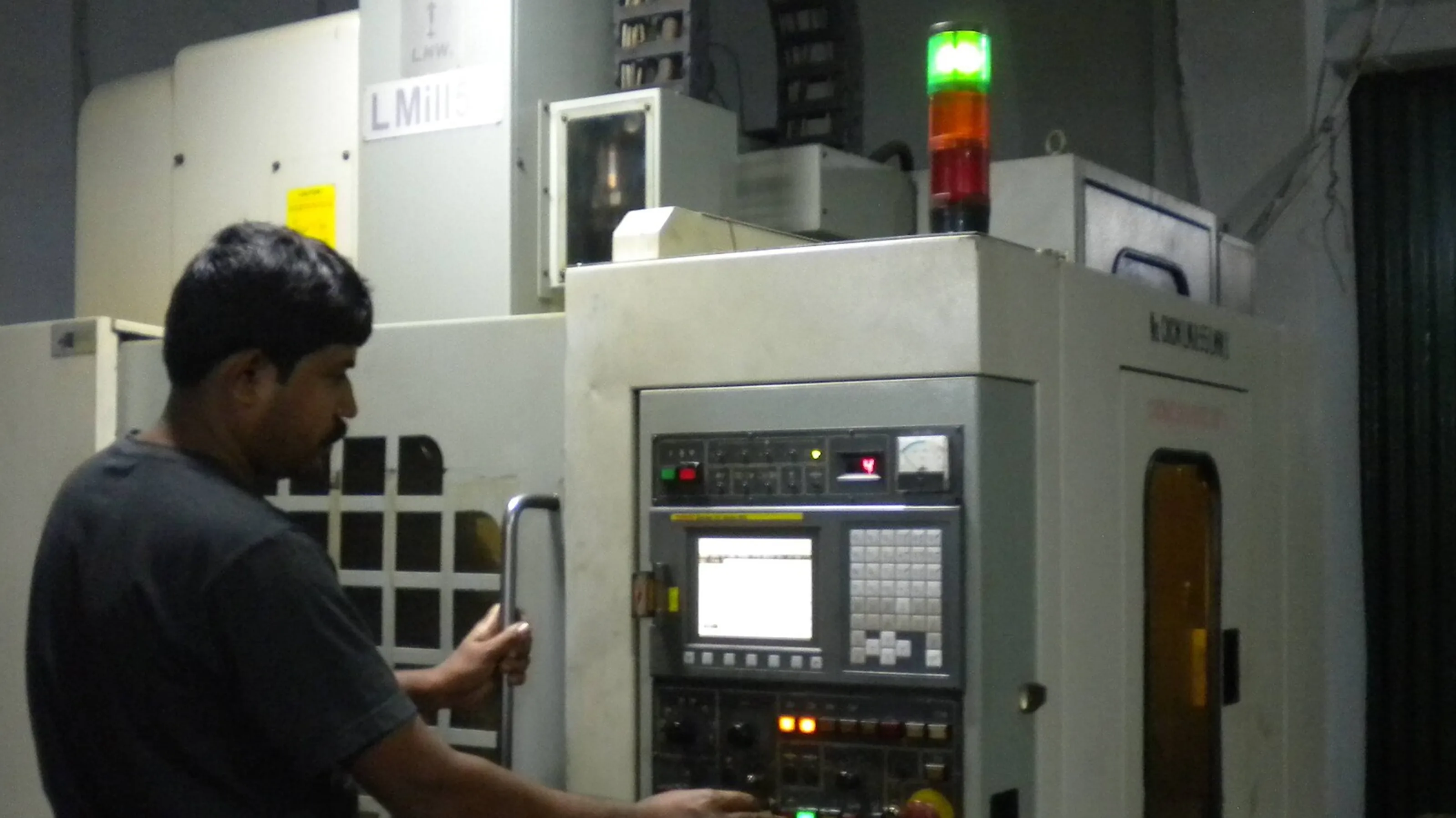 Operator running a CNC machining center on the shop floor