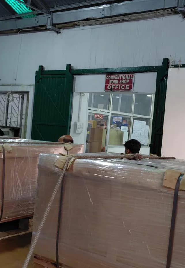 Export crates staged inside the workshop ahead of dispatch